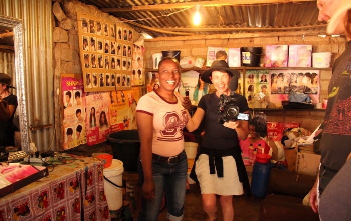 Inside an African Hair Dressing Salon - Ribola Art Route - Ronel and Shop Manager having fun with camera - looking at the photographer