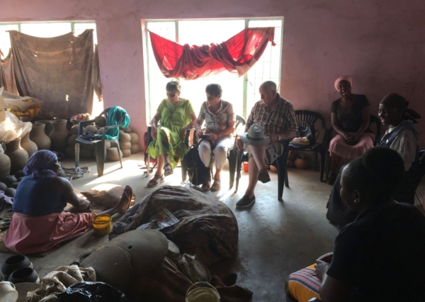 Alexandra's Africa guests Inside Mukondeni Pottery watching one of the ladies creating a clay pot