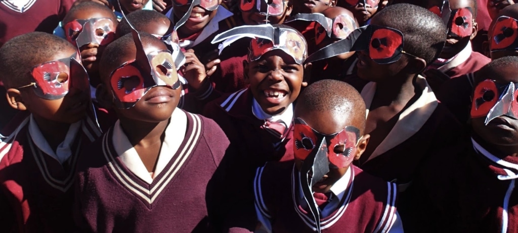 Group of African School Children wearing Ground Hornbill Masks