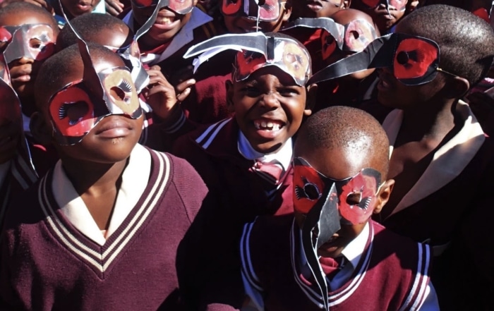 Group of African School Children wearing Ground Hornbill Masks