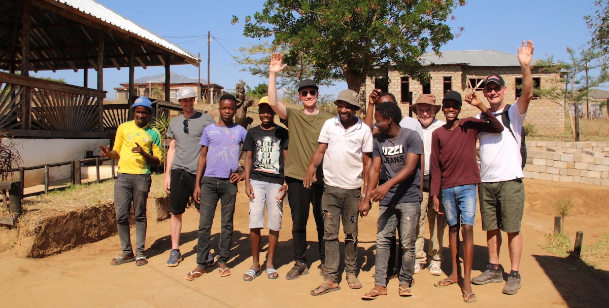 Alexandras Africa Guests happy and smiling standing outside the music studio with Lucky Ntimani and his boy band 