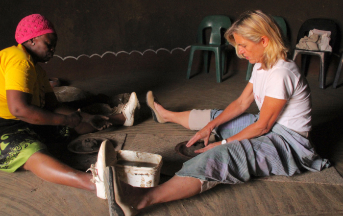 Alexandra being taught how to make Venda clay pots at Mukondeni Village Pottery