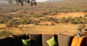 Views from Leshiba Mountain Retreat from the BBQ area into the valley below where there are giraffes walking to a nearby waterhole
