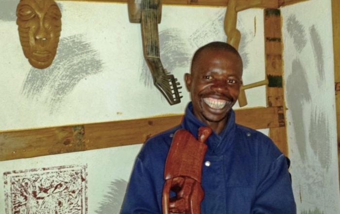 Head & Shoulder picture of Limpopo artist Lucky Ntimani inside his gallery of wood carvings