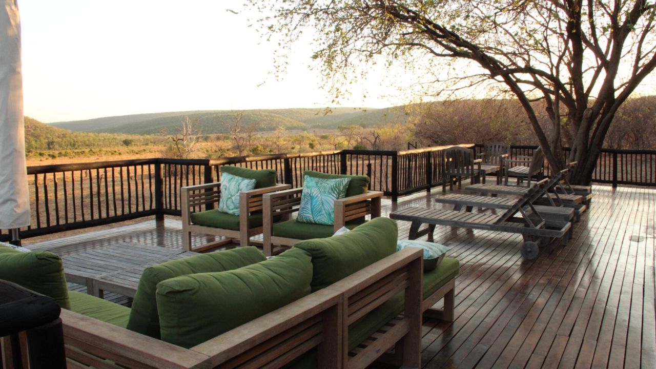 Sun loungers on the wooden terrace of our Safari Lodge with views out over the bushveld